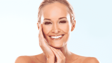 Woman smiling touching her face